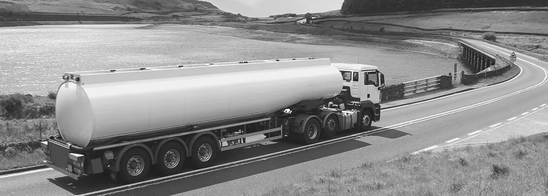 A fuel tanker truck on a coastal highway